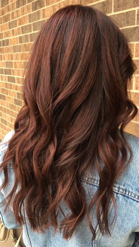 Dark auburn hair dye. Caramel Brown Ombré. Blend chocolate brown and caramel hair colors using a modern ombré technique —when darker roots gradually fade into a lighter brown or blonde tone at the ends. This allows hair to grow out naturally between touch-ups without a harsh line of demarcation. Good hair day by @colorkult. 