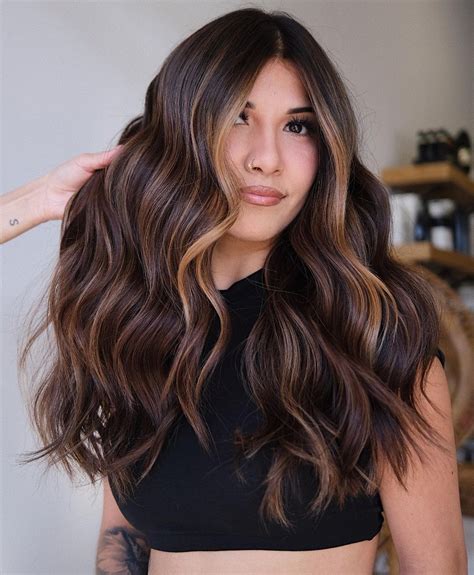 21. Face-Framing Golden Highlights. Save. @romeufelipe. Balayage that focuses on face-framing pieces is a low-maintenance way to freshen up your look. Pops of color will liven up your brunette hair, making your entire look more vibrant and flattering. 22. Natural Light Brown Balayage. Save.