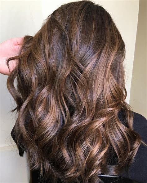 This honey-caramel glazed chocolate brown hair is a serious cause of hair envy. The color is rich, warm, and vibrant. The honey highlights and chocolate brown lowlights create some serious dimensions that will leave even the finest of hair looking dynamic and voluminous. 26. Textured Chocolate Brown.. 