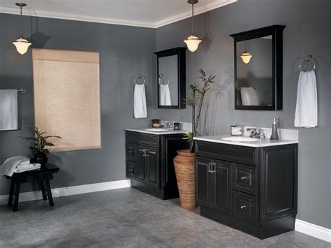 Dark grey bathroom. It really pulls out the gray veining in the marble floor tiles. If your bathroom is cramped or underlit, take a cue from this space’s white walls, accessories and floating contrasting-colored cabinet to make your room feel larger and airier. Try mixing warm and cool shades of gray for a modern yet timeless look. 