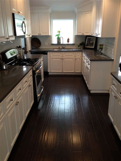 Dark wood floor kitchen. Dark Wood (613) Distressed (69) Gray (2276) Green (208) Light Wood (614) Medium Wood (469) Orange (4) Purple (15) Red (11) Stainless Steel (41) Turquoise (40) ... Kitchen - large transitional l-shaped light wood floor kitchen idea in New York with an undermount sink, shaker cabinets, white cabinets, white backsplash, subway tile backsplash ... 