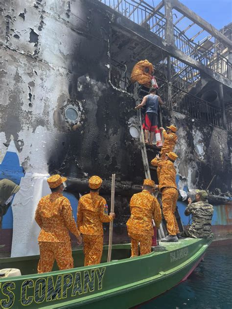 Death scene in burned Filipino ferry moves rescuers to tears