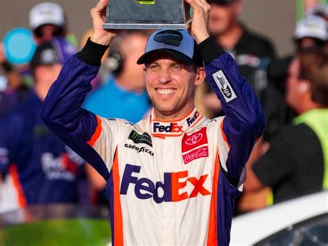FILE - Co-owner Denny Hamlin speaks about his team winning a NASCAR Cup Series auto race at Circuit of the Americas, Sunday, March 26, 2023, in Austin, Texas. A new NASCAR season begins with rivals attempting to dethrone Team Penske after two years atop the Cup Series, all while a compelling off-track battle rages on over revenue …. 