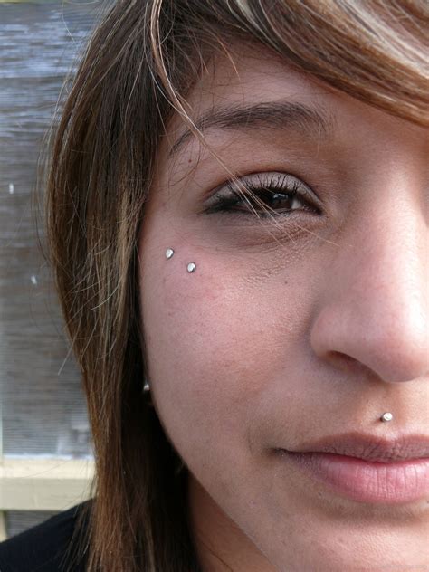 Dermal face piercings. The bar thickness of your dermal anchor is usually 1.6 mm. However, sometimes the dermal anchor could have a thickness of 1.2 mm. Most dermal tops come with a thickness of 1.6 mm. There is no default top size. You can choose between more subtle, smaller tops, or more noticeable larger ones. The most common top sizes go from 3 mm to 5 mm. 