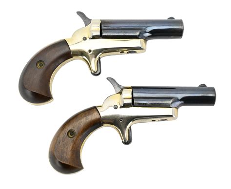 The top barrel has a fixed blade front sight and reads on the left side "Davies Industries Chino CA. USA." The right side of the barrel is stamped "Model D38 .38 SPL." The frame, trigger and hammer all show a blued finish. The Derringer is fixed with the original black plastic factory grips. V2-F2. Barrel Length: 2.75.
