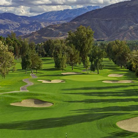 Desert island country club. The 18-hole Desert Island course at the Desert Island Country Club facility in Rancho Mirage, features 6,715 yards of golf from the longest tees for a par of 72. The course rating is 72.0 and it has a slope rating of 131 on Blue grass. Designed by Desmond Muirhead, the Desert Island golf course opened in 1971. 