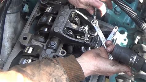 The timing circle can be started with any cylinder. Ensure the circle is completed to set all valves. To adjust the intake valves, insert a 0.279 mm (0.011 in.) feeler gage between the tip of the valve stem and the valve button at the end of the rocker arm. See Figure "Valve Clearance Adjustment Series 60G Engines".. 