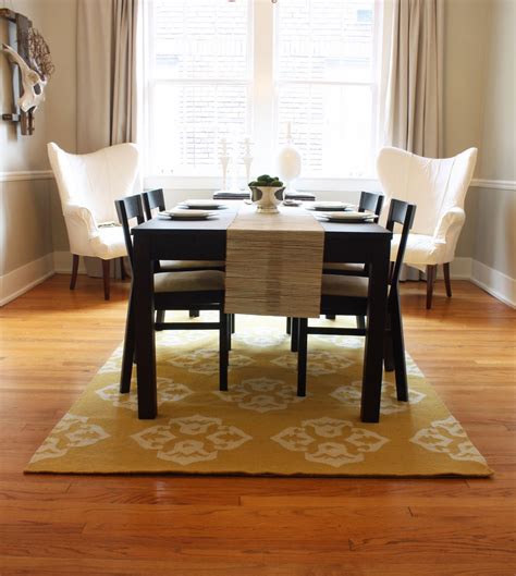 Dining room table rug. Tip: If you have a wooden table, traditional design can work beautifully alongside that decor! Round Rug in a Dining Room. Round rugs are great for small to ... 