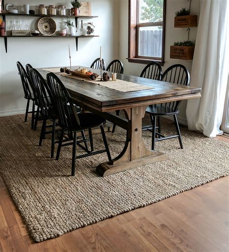 Dining table carpet. In an open space like a living room, a dining table rug helps define the dining area clearly. A dark rug under a light-coloured dining set – and the opposite – creates a contrast that makes the whole group pop quite nicely. Also, a floor protector under the children’s chair is a smart move to make cleaning easier. 
