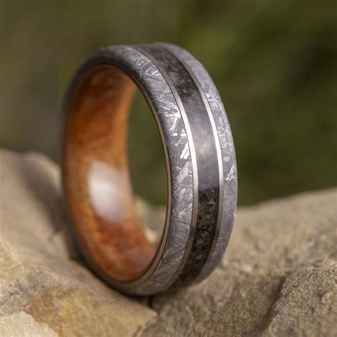 Full of masculine details, this titanium ring is stylish and rugged to match. Gibeon Meteorite fell in prehistoric times in Namibia, Africa. The meteorite created a debris field 171 miles long by 62 miles wide. Dinosaur Bone an Enduring Classic Also known as Gembone, it is the fossil of animal bone that contains gem quality minerals. Its unique .... 