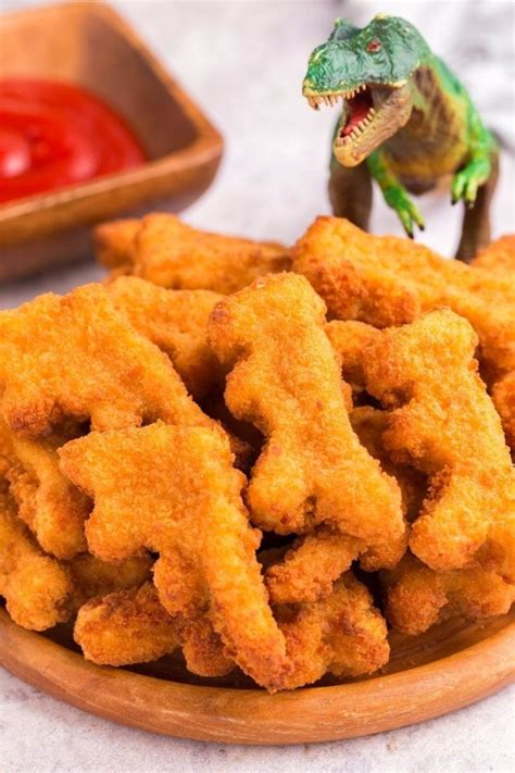 Dinosaur nuggets. Remove the frozen dinosaur nuggets from the packaging and arrange them in the air fryer basket, making sure you are not stacking them. Cook the nuggets for 8-10 minutes until crispy and golden on the outside, flipping the basket or flipping the nuggets halfway through. Serve immediately with a side of fries, mashed potatoes, veggies, and a ... 