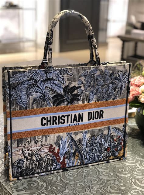 Dior book bag. You can visit a Dior boutique or shop online for any of these bags. The Dior Oblique pattern is the most classic, especially in this blue embroidered colorway. As of July 2022, prices for this embroidered Dior Book tote are as follows: Mini: $2,550 | Small: $3,250 | Medium: $3,350 | Large: $3,500. 