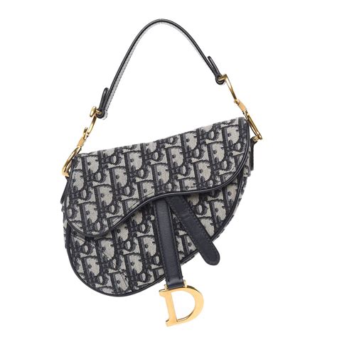 Dior mini saddle bag. Size & Fit. servicesAndAvailabilityInStore. The Saddle bag with strap is a compact and modern creation. Crafted in khaki Dior Oblique jacquard, it features a tonal grained … 