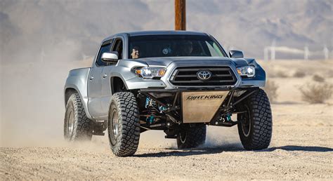 Dirtking - Featured customer Toyota Tacoma build, using Long Travel Kit achieving 13.5” of suspension/wheel travel on 37” wheels. The customer went with our front King shock package. In the rear the customer went with our pre fab bed cage paired with our long travel spring under kit and 3.0” King bypasses.