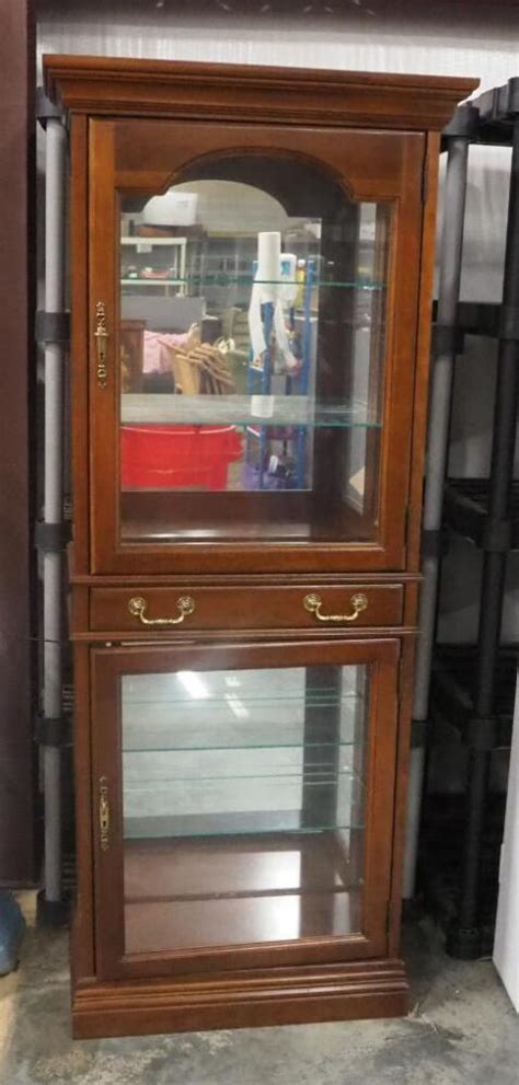 Display cabinet lighting.  The upper compartment has 2 leaded glass panelled ...