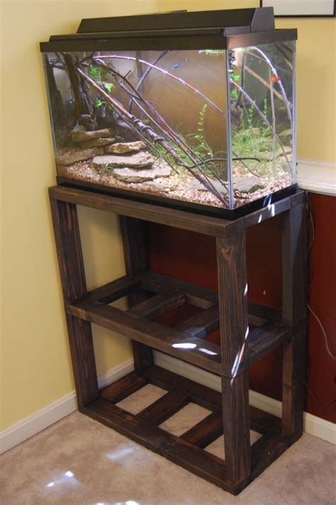 Do it yourself fish tank stand. Rather than take punches at my old stand, which has seen better days, I'd rather use it to point out something to fish owners and the DIY stand builder. The designer of my old aquarium stand knew exactly what he or she was doing. Although made of inexpensive, 1/2" MDF coated in a high gloss melamine, it still holds over 750 pounds. 