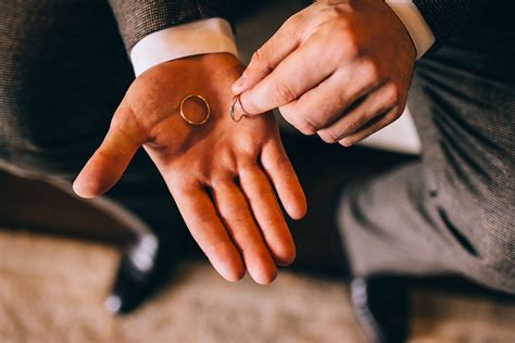Do men wear engagement rings. According to American etiquette experts, the bride’s wedding ring is worn on her left-hand ring finger first, with her engagement ring placed on top of it. The reasoning behind thi... 