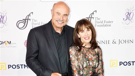 Dr. Phil met his wife, Robin McGraw, at just 19 years old when he went home to visit his parents because he was ill. She looked a bit unkempt, and her hair was dangling everywhere, but that did not stop Phillip from being attracted to her. According to Robin, the feeling was mutual, and she knew he would be the one.. 