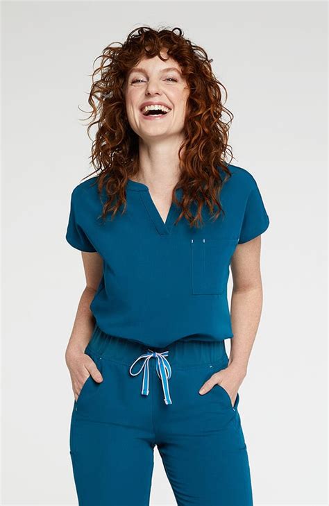 Dolan scrubs. Add embroidery +$15 No Yes. Name Placement. The scrub top everyone needs at least one of. 2 pockets, a relaxed fit, and super smooth fabric. ¾ sleeve makes it perfect for healthcare settings where it’s never not cold. One chest pocket with a pen pocket. Contrast bar tack detail. Printed positive mantra. 
