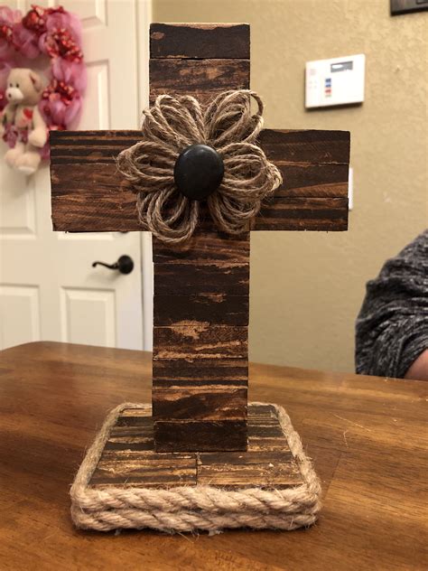 Directions: First, you cut your two sections for the cross and tie them together with Zip Ties. Then you will simply wrap the cross with the rustic burlap ribbon you bought at Dollar Tree fastening it down with your trusty hot glue gun. Then you attach it all at the back with the floral wire, creating a hanger for the door.. 