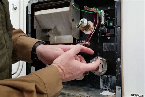 For combination gas and electric water heaters, that reset button may be located out in the WH panel outside your RV. That button may be to the left when you open the panel but it could also be in different positions depending on the model of your RV. That left reset button will reset the 12-volt electrical component and get it fired up again .... 