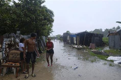 Dominican officials inspect damage inflicted by Tropical Storm Franklin after heavy flooding kills 2