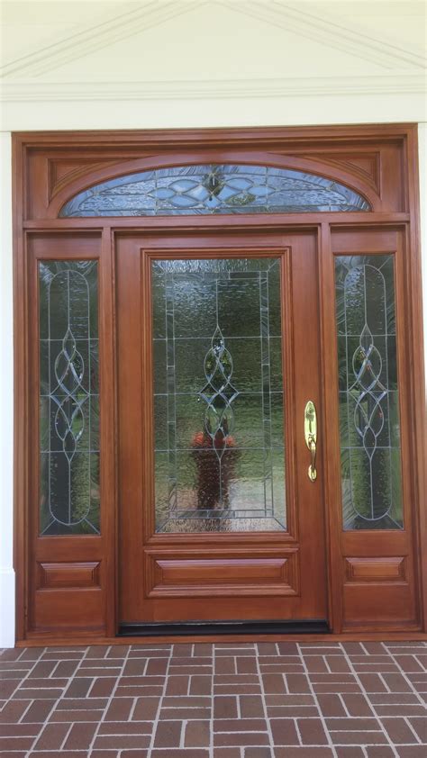 Door refinishing. The cost of refinishing the front door pictured was $ 650.00. The cost of refinishing the garage door pictured was $ 2,700. Both of these doors were refinished ... 