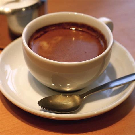 Doppio espresso. How are espresso and doppio made? Espresso and doppio are made using an espresso machine. The machine forces hot water through finely-ground coffee beans to extract the coffee flavor and aroma. The difference between the two beverages lies in the amount of coffee used. Espresso uses a single shot of coffee, while doppio uses a double shot. 