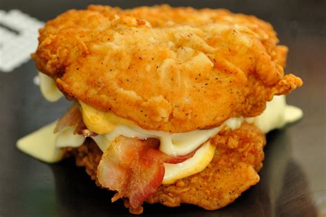 Double down. Forget the bun, the KFC Double Down is the ultimate sandwich for fried chicken lovers. Two juicy and crispy chicken filets, cheese, bacon, and your choice of sauce. Try it today and experience the double deliciousness. 
