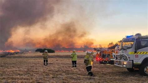 Dozens evacuate and 10 homes are destroyed by a wildfire burning out of control on the edge of Perth