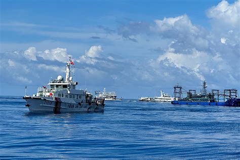 Dozens of Chinese ships chase Philippine vessels as US renews warning it will defend its treaty ally