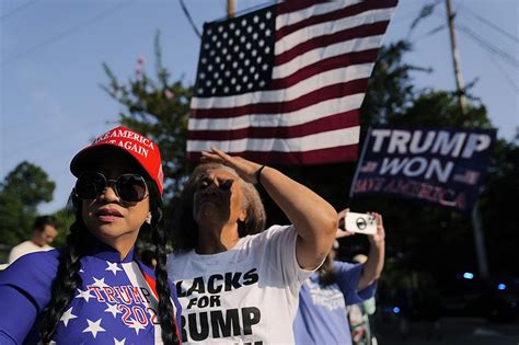 Dozens of Trump fans gather outside Georgia jail to show support ahead of his expected surrender