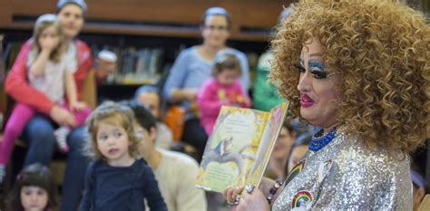 Drag queen story time. Left: Participants dressed in drag dance along with children during the "Drag Queen Story Hour" event, which according to organizers involves participants reading stories to children for an hour ... 