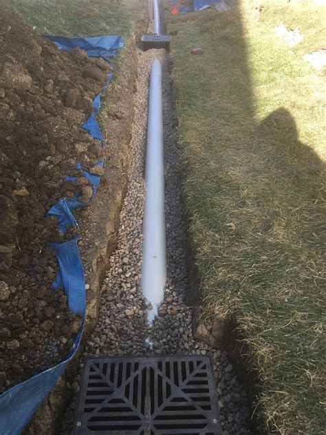 Drain tile system. Our well versed yard and landscape drainage crews will often utilize laser-guided equipment to ensure an ideal slope is kept through the entire drain tile system. This yields to maximum water flow throughout the seasons. If you are dealing with water pooling up on your property, give us a call today at (612) 474-0900 or request a quote online. 