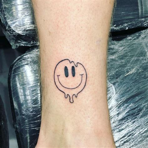 Dripping smiley face tattoo. This design features a bright and cheerful smiley face with dripping paint, creating a modern and unique aesthetic that is sure to turn heads. The dripping paint adds a touch of artistic flair to the design, making it perfect for anyone who loves to express their individuality and stand out from the crowd. #smileyface #smiley #aesthetics # ... 