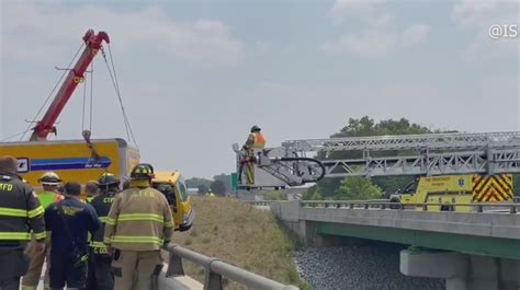 Driver crashes into RV, becomes suspended over bridge on Indiana Toll Road