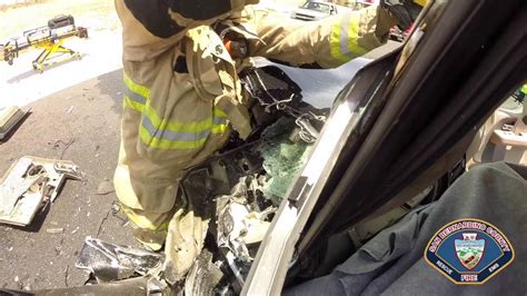 Driver rescued from burning vehicle after crash involving squad car
