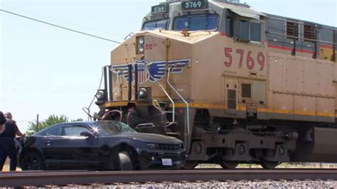 Driver survives after vehicle hit by train in Oakland