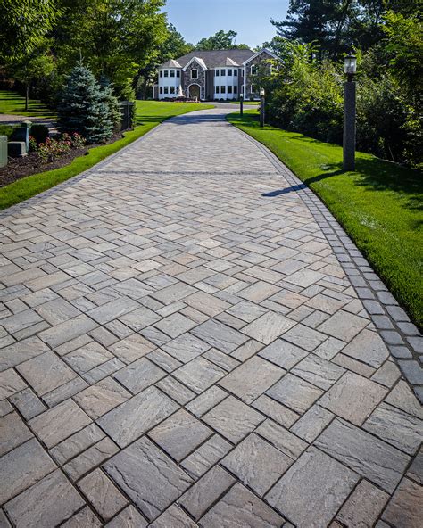 Driveway paver. Plan and design: Your driveway project starts with an assessed design to ensure the construction won't cause drainage and main road issues. Material selection: You can choose poured concrete pavers or paver block driveways for a robust surface that’s easy to maintain. You can also consider stamped concrete driveways or … 