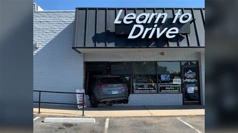 Driving instructor accidentally drives into building