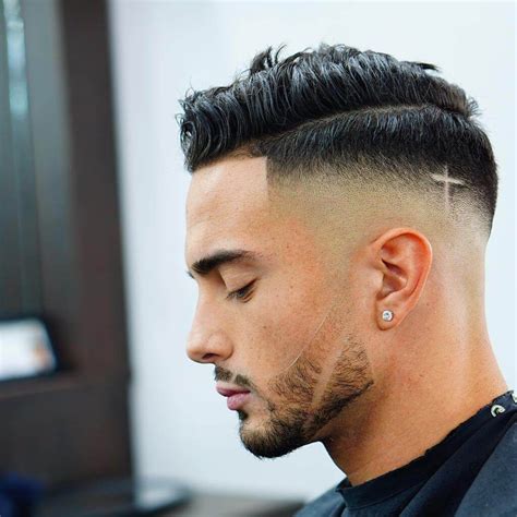 1. Drop Fade. Drop fades add extra personality to your hairstyle, creating a standout 'arc' effect when viewed from the side. The precise, curved line of a drop fade perfectly matches naturally curly hair of any length. However, it looks particularly striking when paired with an Afro or twists.Add a line-up or shaved part for a fresh look.. 2.. 
