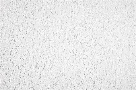 Drywall texture. Let the texture soak for about 15 minutes. Using a scraper or a large drywall knife, start scraping at the top and work your way down. Unpainted texture should peel off easily, making an enormous ... 