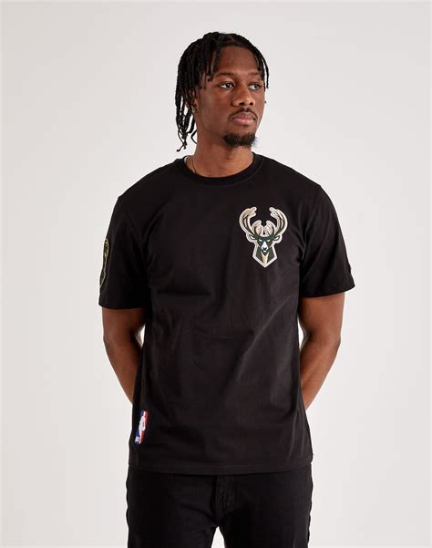 Milwaukee Bucks branding Short sleeves Ribbed crewneck collar Cotton material Rep your squad with this DTLR-exclusive Milwaukee Bucks Tee from Pro Standard. This comfortable men's T-shirt features team embroidery on the chest and sleeve. . 