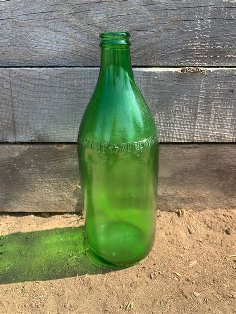 Vintage 6 oz. Windex bottle with a tiny bit of liquid still inside. The Windex label is intact and the opposite side (with directions) has a copyright date of 1950. The twist cap is advertising Twinkle Paste Copper Cleaner. This bottle is marked Duraglas on the bottom and Windex is embossed on the
