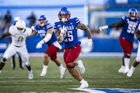 Kansas running back Dylan McDuffie (25) scores a touchdown during the second half of an NCAA college football game against Central Florida, Saturday, Oct. 7, 2023, in Lawrence, Kan.. 