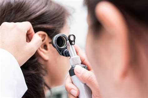 Ear examination using an otoscope - Alberta