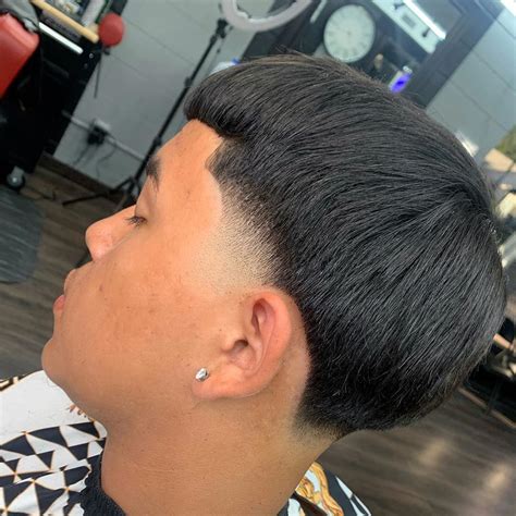 Fluffy Edgar Cut Taper Fade Haircut Source: @sergiobarron_ via Insta Source: @sergiobarron_ via Insta. One way to add structure to a fluffy Edgar is to get it with a taper fade haircut. Ask your barber to taper the back and sides down close to the skin near the hairline, then quickly blend up to longer fluffy hair on top.