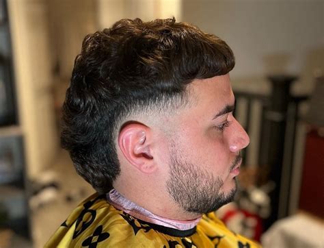 The short Edgar haircut has many variations. The most common one has long curly hair in the back. Some can grow to full bushy mullets, but you can also opt for a short version with blunt fringe. The trick to styling your Edgar haircut is to keep the fringe and sides wavy. 3. High Fade Edgar Haircut. 