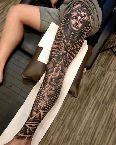 Egyptian leg sleeve tattoos. Black and grey realistic leg tattoo of Anubis, God of the embalming and the dead by Alo Loco, best London tattoo artist, top UK. 