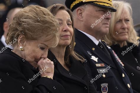Dec. 9 | Washington. A military bearer party takes the casket up the steps of the U.S. Capitol as former U.S. senator Elizabeth Dole, the late former senator’s wife, stands at the top of the ...